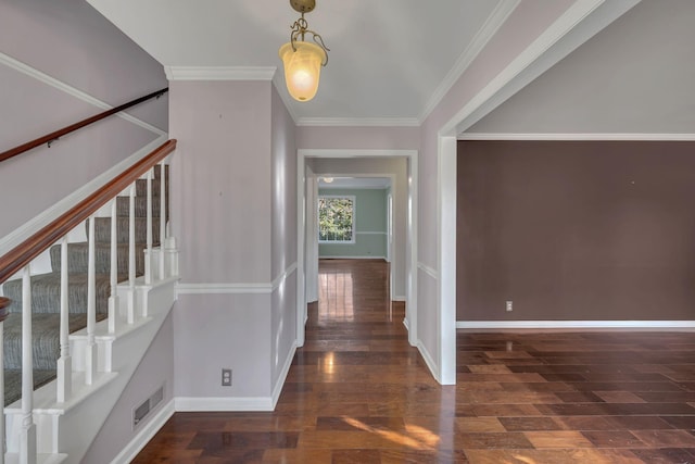 entryway featuring dark wood-type flooring and ornamental molding