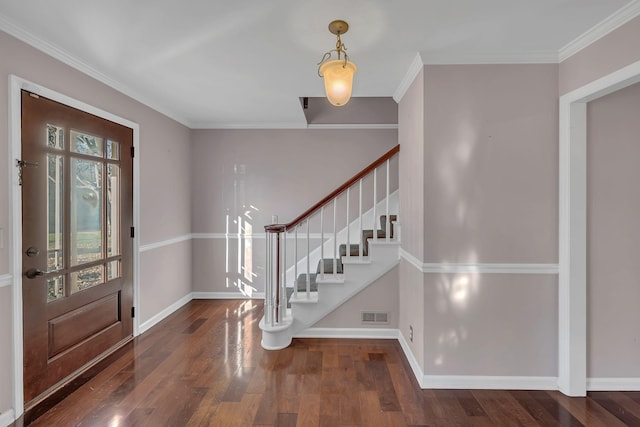 foyer entrance with crown molding and dark hardwood / wood-style flooring