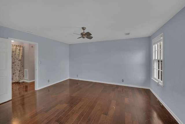 spare room with ceiling fan and dark hardwood / wood-style floors