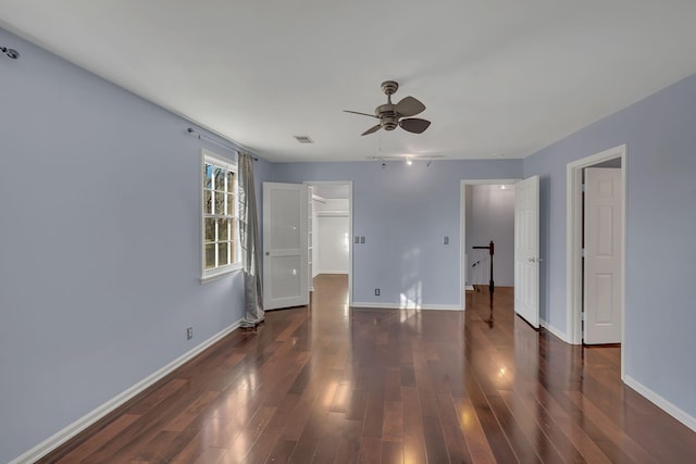 empty room featuring dark hardwood / wood-style flooring and ceiling fan