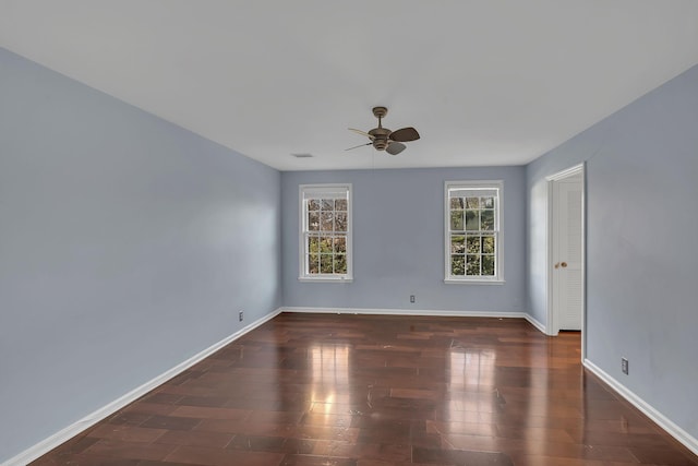 spare room featuring ceiling fan and dark hardwood / wood-style floors