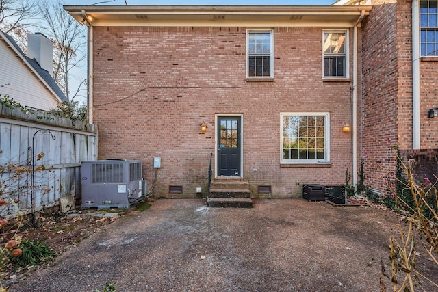 rear view of property with a patio area and central air condition unit