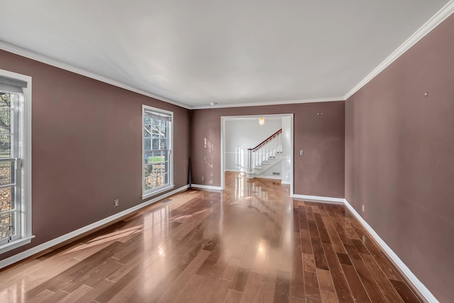 empty room featuring hardwood / wood-style floors and ornamental molding