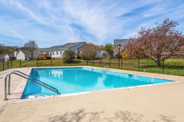 view of pool featuring a yard