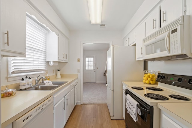 kitchen featuring white cabinets, white appliances, light hardwood / wood-style flooring, and sink