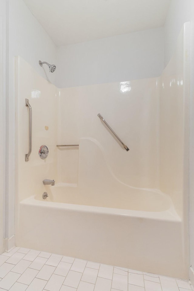 bathroom featuring tile patterned flooring and  shower combination