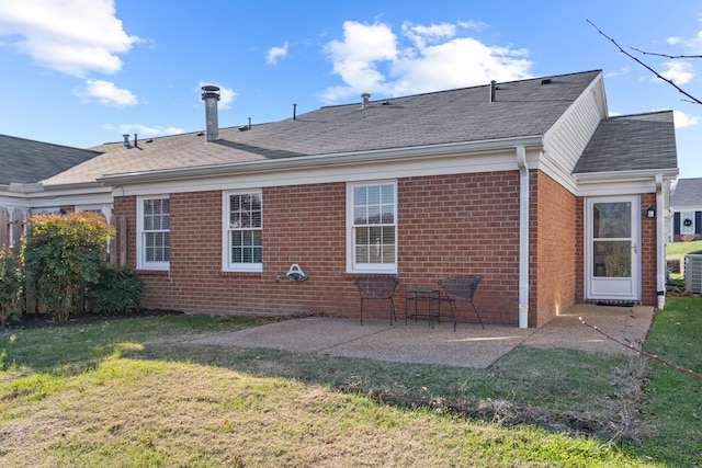 rear view of house with a patio and a lawn