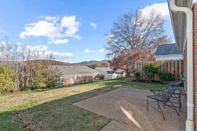 view of yard featuring a mountain view and a patio