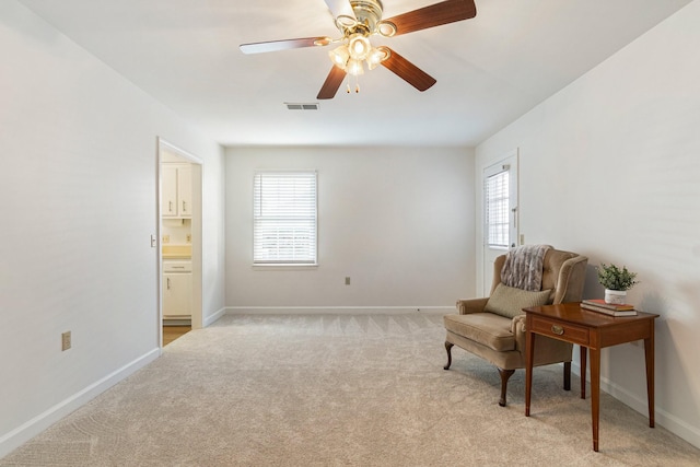 sitting room featuring ceiling fan and light colored carpet