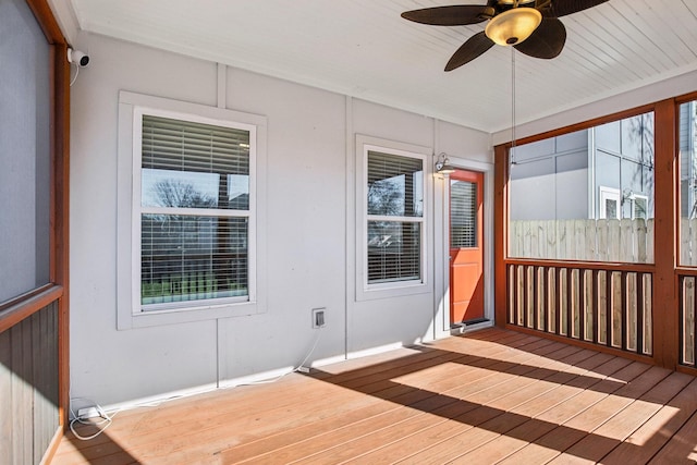 unfurnished sunroom with ceiling fan