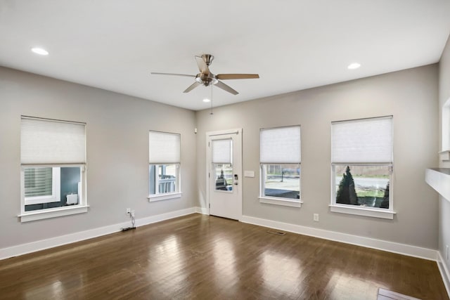 interior space featuring ceiling fan and dark wood-type flooring