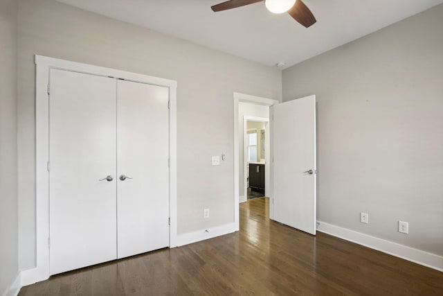 unfurnished bedroom with a closet, dark hardwood / wood-style floors, and ceiling fan