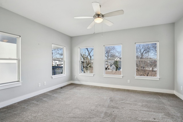 empty room with ceiling fan and carpet floors