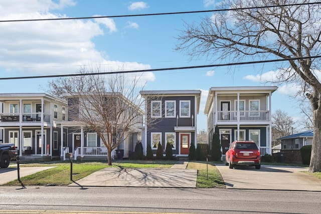 view of front of home with a porch, a balcony, and a front yard