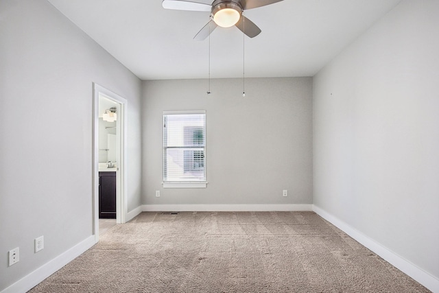 carpeted empty room with ceiling fan and sink