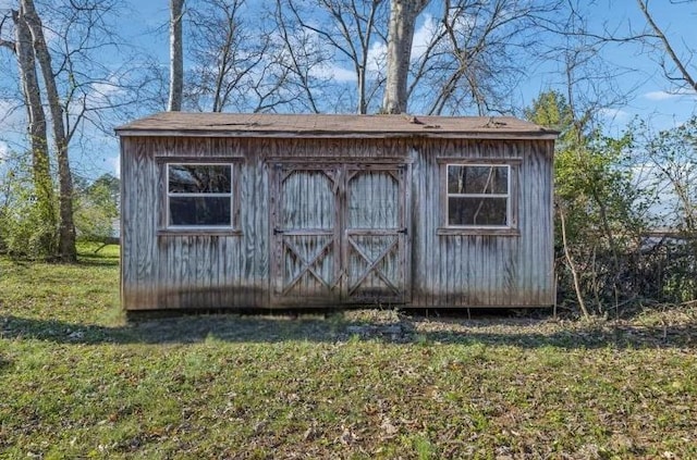 view of outbuilding featuring a yard