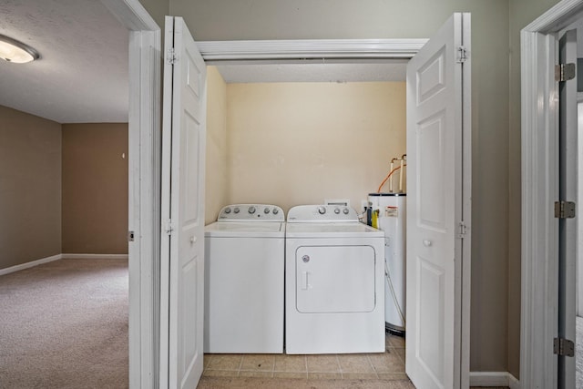 laundry room with water heater, light tile patterned floors, and independent washer and dryer