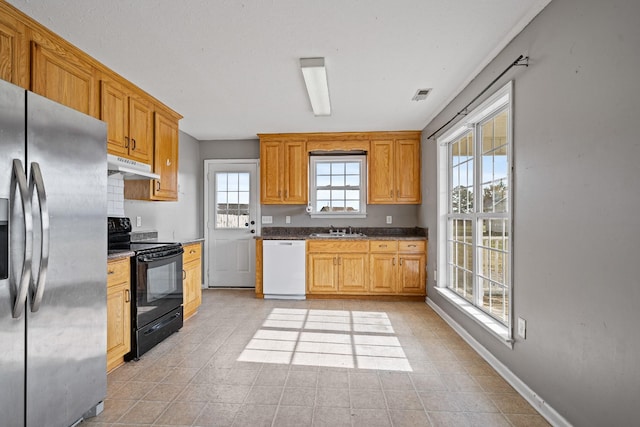 kitchen with dishwasher, stainless steel fridge, black range with electric cooktop, and sink