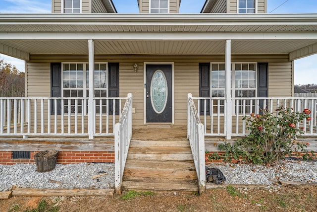 view of exterior entry with covered porch