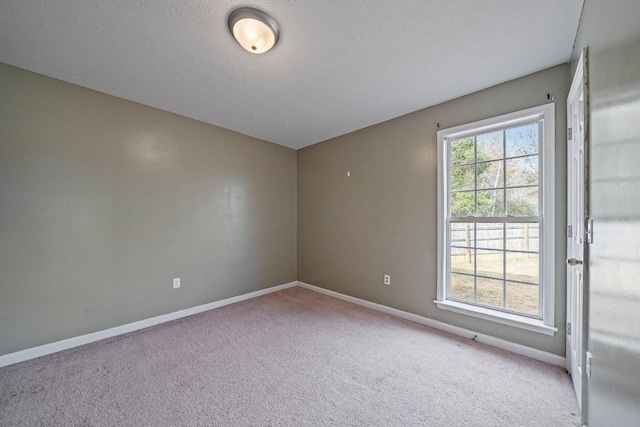 unfurnished room with light carpet and a textured ceiling