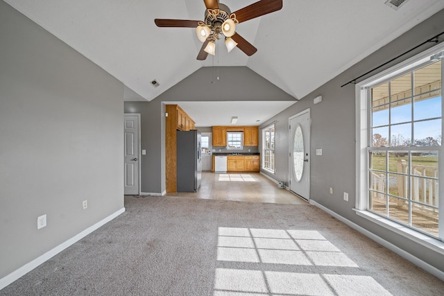 unfurnished living room featuring ceiling fan, plenty of natural light, and lofted ceiling