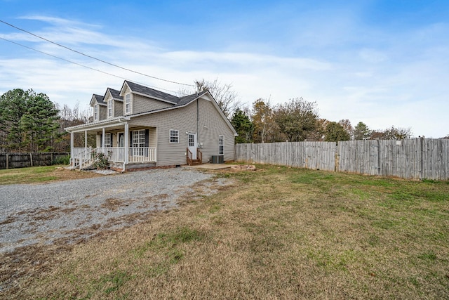 view of home's exterior featuring covered porch and a yard