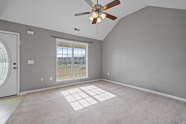 foyer entrance with ceiling fan, light carpet, and vaulted ceiling