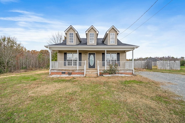 cape cod home featuring a porch and a front yard