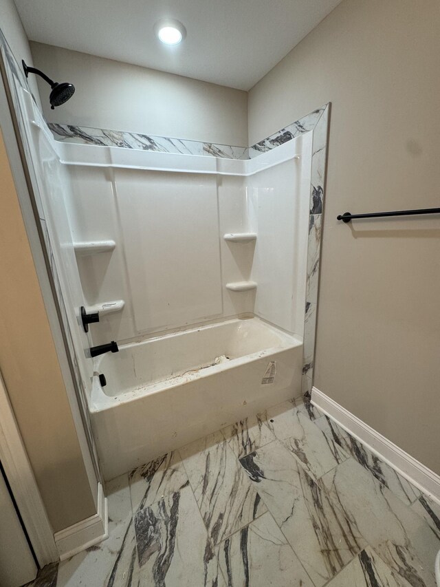 bathroom with marble finish floor, bathtub / shower combination, baseboards, and recessed lighting