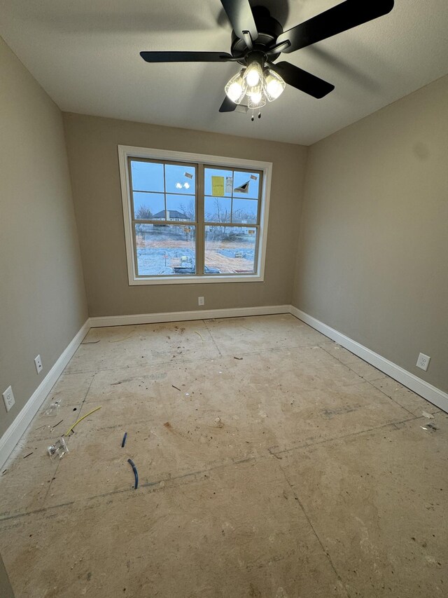 unfurnished room with baseboards and a ceiling fan