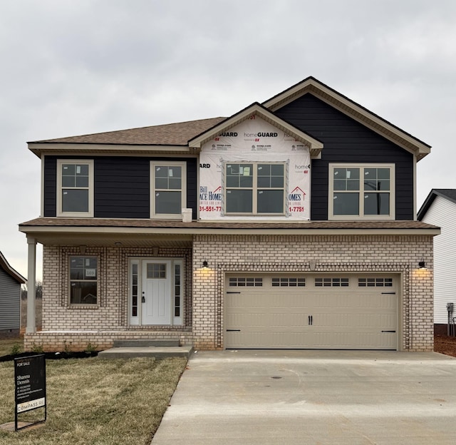 view of front of property featuring brick siding, driveway, and an attached garage