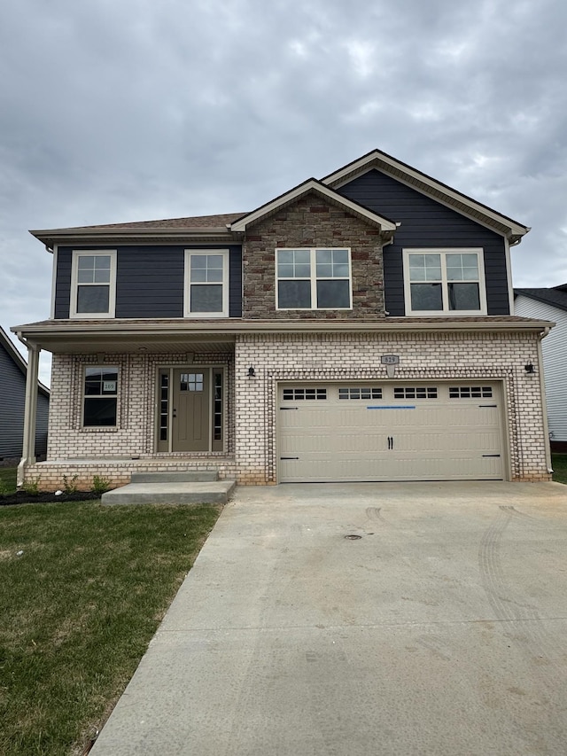 169 Anderson Pl, Clarksville, TN 37040 - view of front facade with concrete driveway, brick siding, a front yard, and a garage