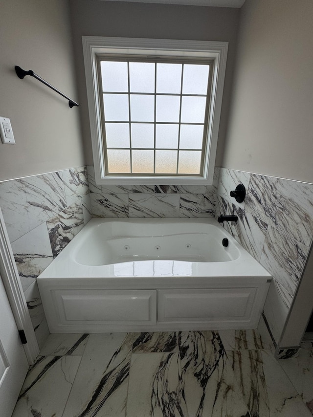 169 Anderson Pl, Clarksville, TN 37040 - bathroom featuring tile walls, a wainscoted wall, a jetted tub, and marble finish floor
