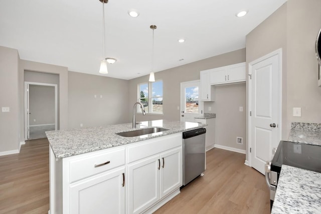 kitchen featuring white cabinets, sink, hanging light fixtures, an island with sink, and stainless steel appliances