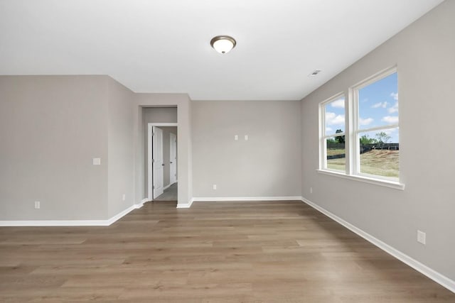 spare room featuring light wood-type flooring