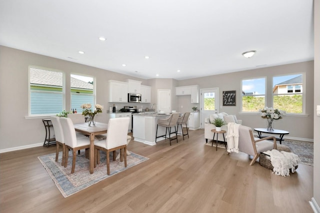 dining space featuring sink and light hardwood / wood-style flooring