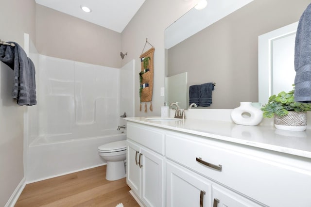 full bathroom featuring shower / tub combination, hardwood / wood-style floors, vanity, and toilet