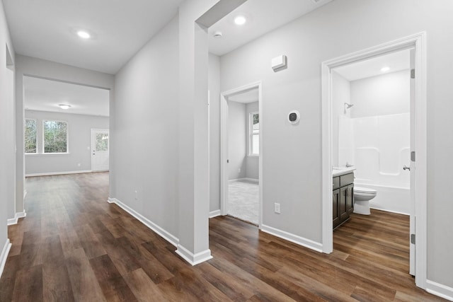 corridor with dark hardwood / wood-style flooring