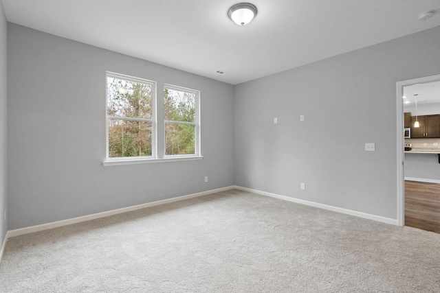 unfurnished room featuring carpet