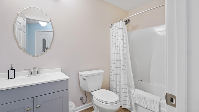 full bathroom with vanity, toilet, a textured ceiling, and shower / tub combo