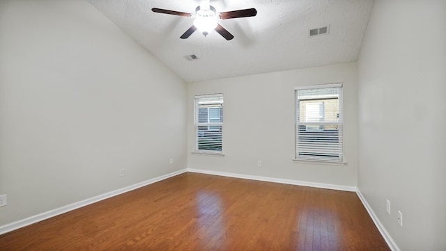 spare room featuring wood-type flooring, a textured ceiling, ceiling fan, and lofted ceiling