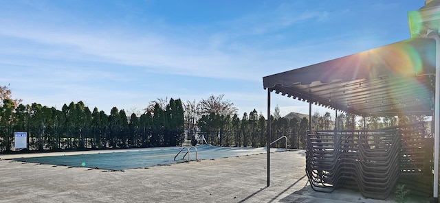 view of swimming pool with a patio