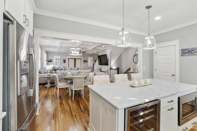 kitchen with wine cooler, white cabinetry, stainless steel appliances, and coffered ceiling