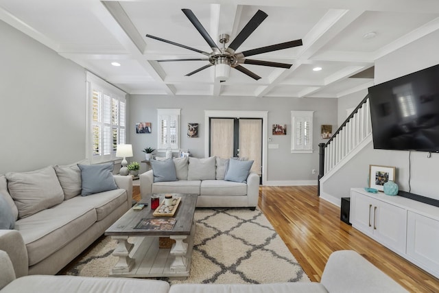 living room featuring beam ceiling, light hardwood / wood-style flooring, and coffered ceiling