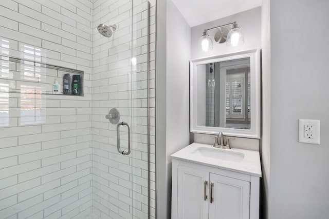 bathroom featuring vanity and a shower with shower door