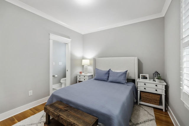 bedroom with ensuite bathroom, dark hardwood / wood-style flooring, and ornamental molding