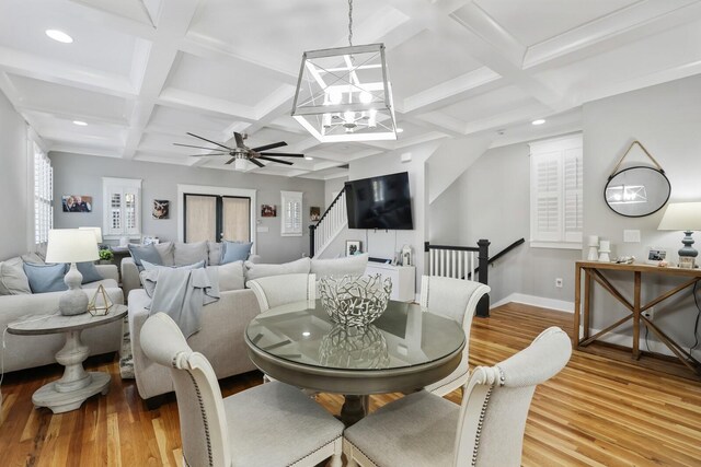 dining space with wood-type flooring and beam ceiling