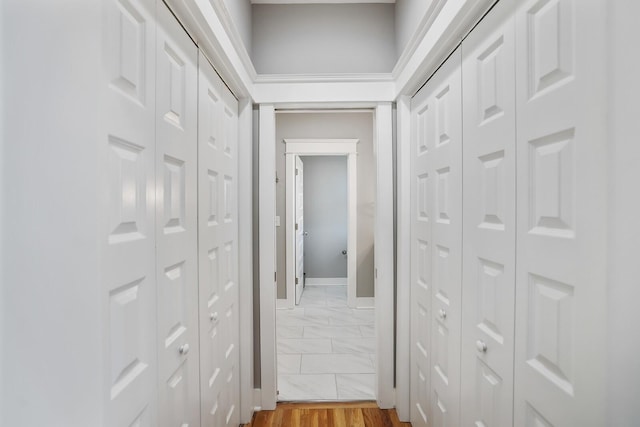 hallway with hardwood / wood-style flooring