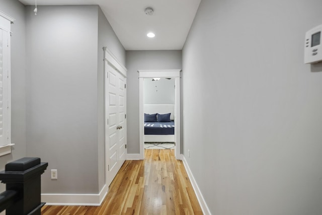 hallway with hardwood / wood-style floors