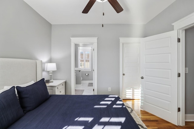 bedroom with connected bathroom, ceiling fan, and hardwood / wood-style floors